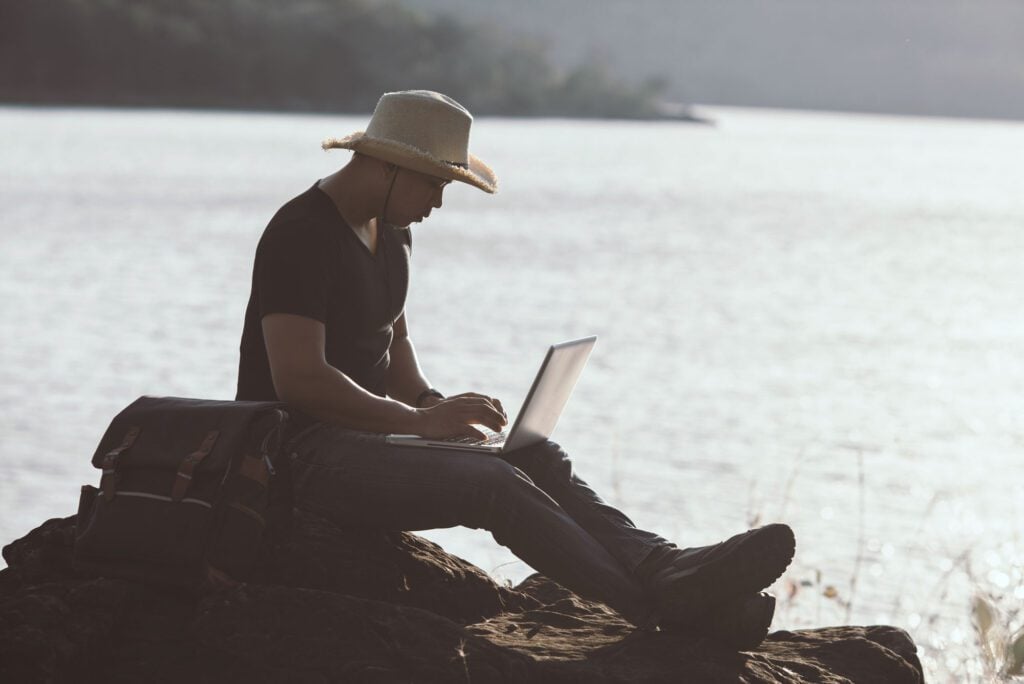 Man working at laptop in nature